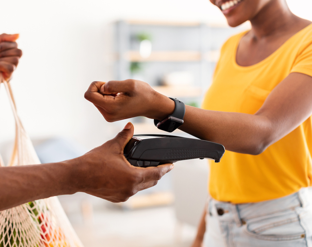 Woman tapping watch at POS