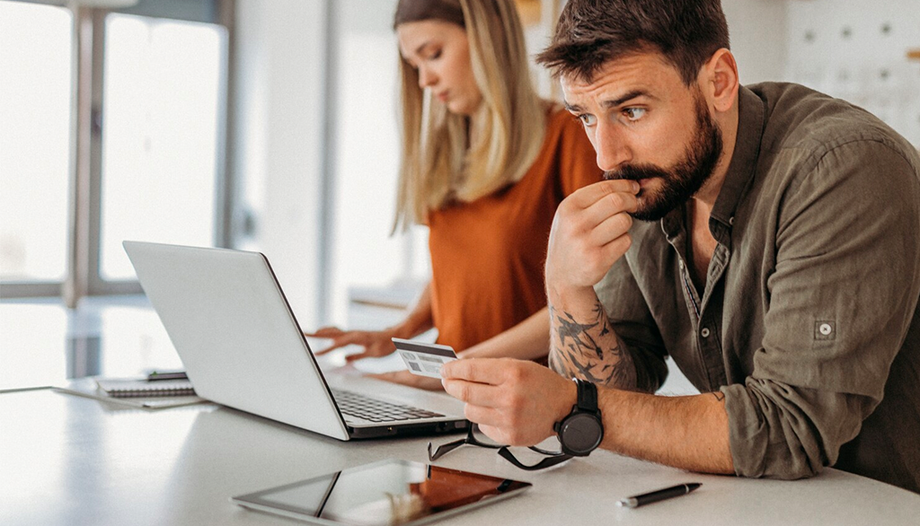 Man looking at credit card